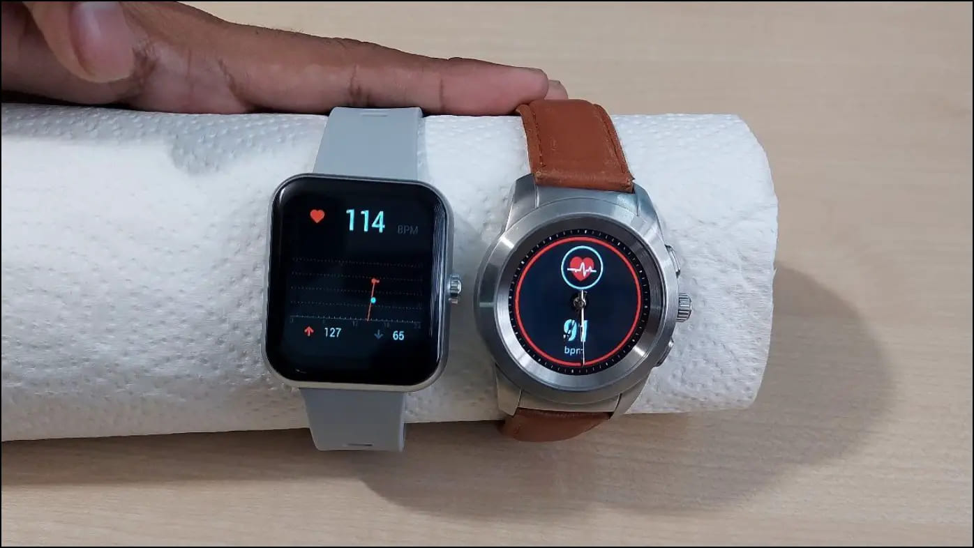 Smartwatches Showing Heart Rate Numbers on Tissue Roll