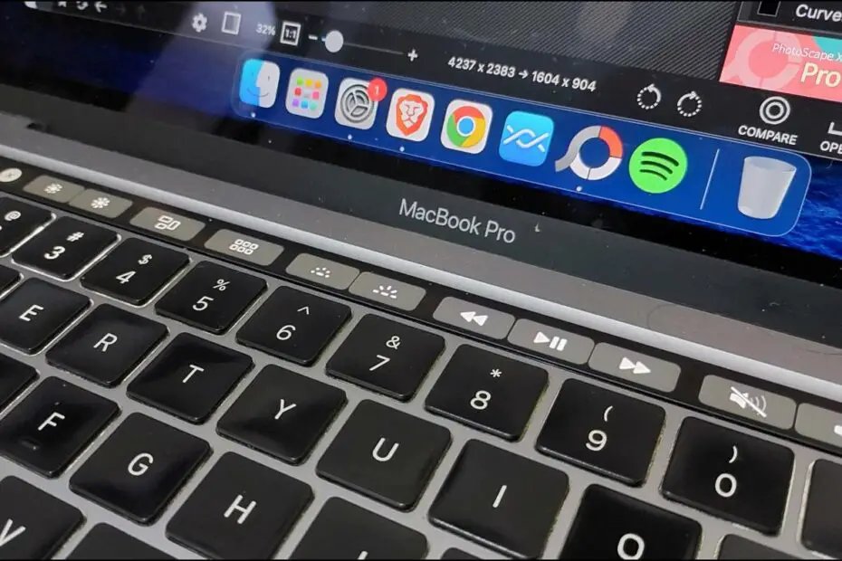 MacBook with Touchbar Showing Keyboard Brightness Buttons